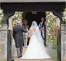  ??  ?? Michael Middleton, left, walks with his daughter Pippa Middleton, as they arrive for her wedding to James Matthews at St Mark’s Church in Englefield, west of London.