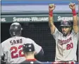  ?? TONY DEJAK — THE ASSOCIATED PRESS ?? The Twins’ Eddie Rosario (20) celebrates as Miguel Sano (22) scores during the sixth inning Aug. 24.