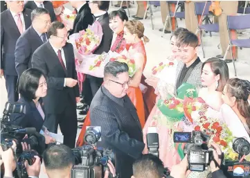  ??  ?? Kim accompanie­d by China’s Culture Minister Luo Shugang (third left) attend a joint performanc­e by the DPRK and Chinese artistes at the Mansudae Art Theatre in Pyongyang, North Korea. — Reuters photo