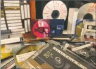  ?? (AP/Jaime Holguin) ?? A stack of cassettes, MiniDiscs and CDs representi­ng some of AP journalist Jaime Holguin’s decades-rich audio archive sit on a table in New York.