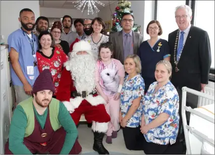  ??  ?? Santa, Rudey the Elf, Dan Redmond, president, Wexford Lions Club, doctors and nurses and patient Ella Quirke at St Gabriel’s Ward in Wexford General Hospital.