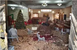  ?? — AP ?? A Pakistani man walks in the main hall of a church following a suicide attack in Quetta, Pakistan, on Sunday.