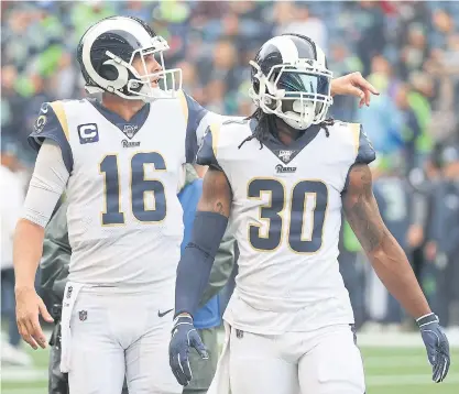  ??  ?? Rams quarterbac­k Jared Goff, left, and running back Todd Gurley warm up before a game this month.