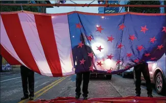  ?? JAY JANNER / AMERICAN-STATESMAN ?? Above: Austin firefighte­rs (from left, above) Hunter Bagent, Capt. Mark Bridges and Marcus De Leon raise the U.S. flag at the 9/11 memorial service at the downtown Buford Fire Tower.