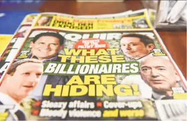  ?? Stephanie Keith / Getty Images ?? Friday’s cover of the National Enquirer. Jeff Bezos, CEO of Amazon and pictured lower right on the tabloid’s cover, claims the Enquirer’s publisher, American Media Inc., tried to extort and blackmail him.