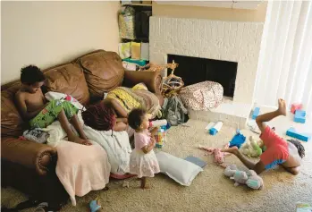  ?? ERIN SCHAFF/THE NEW YORK TIMES ?? T., a 27-year-old mother, rests while her children play June 14 near Dallas. T. gave birth to her fourth child, and first post-Roe baby, two days after the Supreme Court decision that overturned the right to getting an abortion.