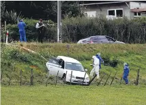  ?? Picture / Dean Purcell ?? Police at the scene near Waiuku where they are continuing their inquiry into how the woman came to be in the paddock.