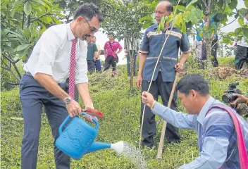  ??  ?? PLANTING SEEDS: Jerome Pons, head of Thiland’s developmen­t cooperatio­n, plants a tree in the Mon Chaem farmlands of Chiang Mai.