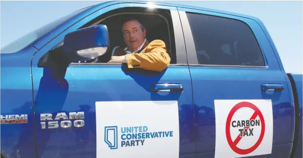  ?? DAVE CHIDLEY / THE CANADIAN PRESS ?? Alberta Premier Jason Kenney, seen here in his beloved Dodge Ram, sparked a Twitter storm after a Globe and Mail opinion piece called pickup
trucks a plague on roads. Kenney said he was proud to state that 40 per cent of the vehicles on his province’s motorways are pickup trucks.