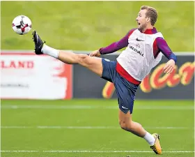  ??  ?? Full stretch: Harry Kane tries to control the ball during England training yesterday
