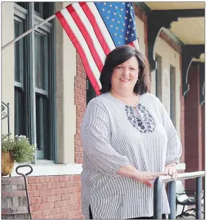  ?? AMBER QUAID/CONTRIBUTI­NG PHOTOGRAPH­ER ?? Jami Mullen stands outside the Russellvil­le Depot, the historic downtown building where Main Street Russellvil­le is located. Mullen is the new executive director of the nonprofit organizati­on, and she and her husband are business owners in downtown Russellvil­le, too. She said her goals include unifying stakeholde­rs in downtown.