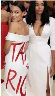  ?? Getty imageS file ?? WOKE WARDROBE: Alexandria Ocasio-Cortez, left, wears a gown designed by Aurora James to last month’s Met Gala in New York City.