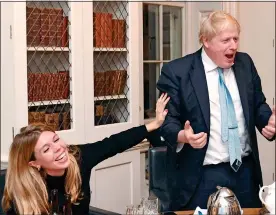  ??  ?? RESULT! Boris and Carrie can’t hide their glee as they hear the exit poll in No10