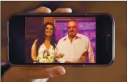  ?? DAI SUGANO — STAFF PHOTOGRAPH­ER ?? Stacey Silva, of Gilroy, shows a picture of herself and her father, Gary Young, taken when she got married in 2019. Her father died of COVID-19 last March.