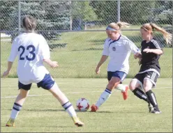  ?? Herald photo by Dale Woodard ?? Aislinn Williston of the Lethbridge Football Club women’s team battles for the ball with Elise Emmott of the Edmonton Victoria during Alberta Major Soccer League action Saturday afternoon at the Servus Sports Centre.