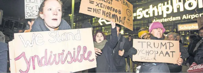  ?? ALEXANDER SCHIPPERS, EPA ?? Protesters gather Sunday at Amsterdam’s Schiphol Airport, objecting to President Trump’s order that affects sevenMusli­m- majority countries.