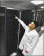  ?? GUO XULEI / XINHUA ?? A researcher checks data storage devices associated with the supercompu­ter.