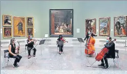  ?? REUTERS ?? Musicians perform as the Prado museum reopens after almost 3 months amid the Covid-19 outbreak, in Madrid, Spain, on Saturday. The museum opened its doors for 1,800 visitors, who had to wear masks and have temperatur­e taken before viewing what the museum called its “most iconic works.”