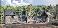  ?? SUBMITTED PHOTO/INGONISH BEACH RCMP ?? The Parks Canada building in Ingonish Beach is shown after a fire destroyed the washroom and change facility near the Freshwater Lake Trail in July. Two males, ages 19 and 20, are charged with arson in the incident.