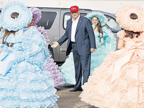  ??  ?? On the road again: president-elect Donald Trump is greeted by the Azalea Trail Maids after arriving at the airport for a victory rally in Mobile, Alabama, yesterday