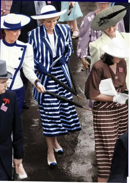  ??  ?? Brolly good fun: Diana and Fergie playfully prod their friend’s posterior at Royal Ascot in 1987
