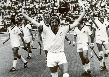  ??  ?? Wing-half Alan Chesney celebrates victory as the jubilant New Zealand team walk off the turf after their 1-0 win over Australia.