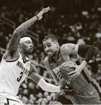  ?? Karen Warren / Staff photograph­er ?? Forward Torrey Craig, left, defends against Houston forward Thabo Sefolosha last season with Denver. Craig, 29, has signed a free agent contract with the Milwaukee Bucks.