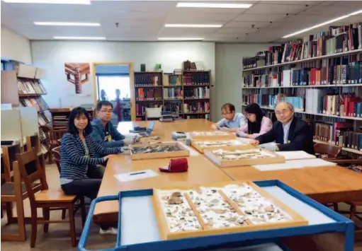  ??  ?? August 24, 2018: Huang Tianshu (rightmost) and his students are researchin­g pieces of oracle bone inscriptio­ns at the Royal Ontario Museum in Toronto, Canada. courtesy of Huang Tianshu