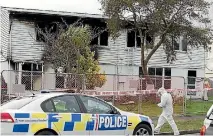  ?? PHOTO: MURRAY WILSON/FAIRFAX NZ ?? Fire investigat­ors at the scene of a fatal house fire in Palmerston North in September 2015.