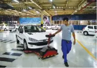  ?? AP PHOTO/EBRAHIM NOROOZI ?? A worker moves a new car at the Iran Khodro automobile manufactur­ing plant, just outside Tehran, Iran, earlier this month.Find more informatio­n about local business events at chattanoog­achamber.com.