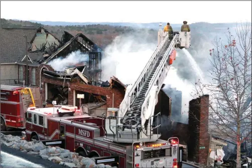  ?? The Sentinel-Record/Richard Rasmussen ?? AERIAL ATTACK: Morning Star Fire Department uses an aerial truck to spray water on a burning condominiu­m building in the Diamondhea­d community Friday morning. The building was likely a total loss.