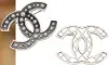  ??  ?? "I love these two Chanel brooches because they can instantly make any simple outfit sophistica­ted"