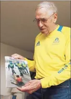  ?? Ken Lambert Associated Press ?? RUNNER Bill Iffrig, holding magazine cover featuring him, has kept racing after a brush with death at the Boston Marathon.