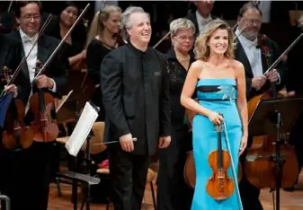 ?? Kai Bienert/Mutesouven­ir ?? Music director Manfred Honeck and German violinist Anne-Sophie Mutter with the PSO in Berlin in 2013. The PSO has performed to critical acclaim in dozens of countries.