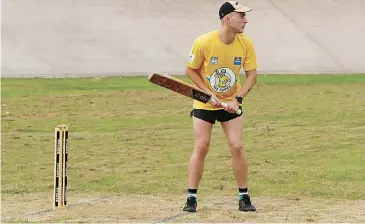  ??  ?? Captain coach Sam Batson gets set to face his next ball. Each batsman had 12 balls to put as many runs on the board as they could.