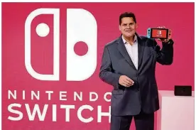  ?? NEILSON BARNARD/GETTY IMAGES FOR NINTENDO OF AMERICA ?? In this photo provided by Nintendo of America, Nintendo of America President and COO Reggie Fils-Aime debuts the groundbrea­king Nintendo Switch at a press event in New York on Jan. 13.
