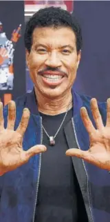  ??  ?? Lionel Richie says getting his handprints at the forecourt of the iconic Los Angeles theatre was a childhood dream PHOTO: JORDAN STRAUSS/INVISION/AP