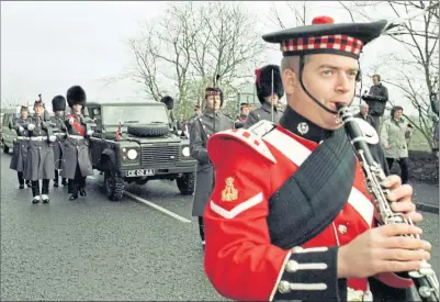  ??  ?? An Army band leads Land Rover carrying the Stone of Destiny as it is escorted back into Scotland at Coldstream in the Borders in 1996