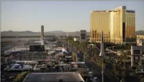  ?? JOHN LOCHER — THE ASSOCIATED PRESS ?? The Mandalay Bay resort and casino, right, overlooks an outdoor festival grounds across the street, left, Tuesday in Las Vegas. Authoritie­s said Stephen Craig Paddock broke the windows on the casino and began firing with a cache of weapons, killing...