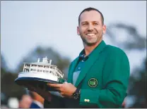  ?? Associated Press photo ?? Sergio Garcia, of Spain, holds his trophy at the green jacket ceremony after the Masters golf tournament Sunday in Augusta, Ga.