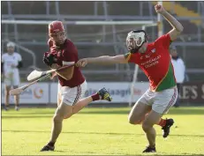  ??  ?? Richie Foley of Rapparees puts pressure on Daithi Waters of St. Martin’s during their Senior hurling championsh­ip match.