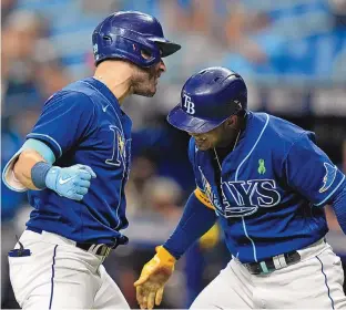  ?? CHRIS OMEARA/ASSOCIATED PRESS ?? Tampa Bay’s Kevin Kiermaier, left, celebrates with teammate Wander Franco after scoring on an inside-the-park home run during Tuesday’s game against the Miami Marlins in St. Petersburg, Fla.