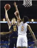  ?? Getty Images/tns ?? California forward Lars Thiemann, left, shoots as UCLA guard Chris Smith, right, defends during the second half of an NCAA college basketball game on Jan. 19 in Los Angeles. UCLA won, 50-40.