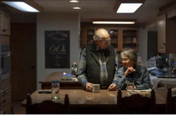  ?? PHOTOS BY ERIN SCHAFF — THE NEW YORK TIMES ?? Jim and Sue Chilton eat lunch Jan. 11at home on their ranch, which abuts the Mexico border for more than five miles near Arivaca, Ariz. The Chiltons have spent years trying to reckon with it all: a humanitari­an disaster, a drug crisis, a national security emergency and a political battle, all playing out within the remote confines of their ranch.