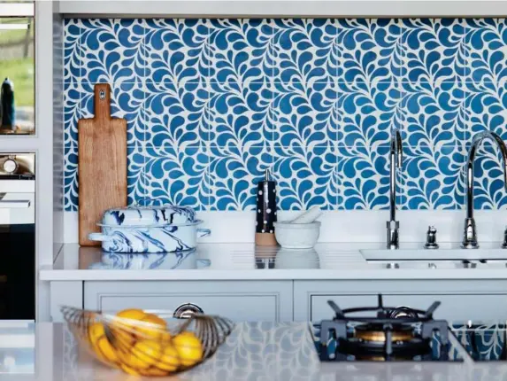  ?? (Tom Howley) ?? A Tom Howley kitchen with Mediterran­ean-inspired tiles and rustic accessorie­s – kitchens start at £20,000