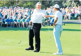  ?? Picture / Getty Images ?? Phil Mickelson (left) and Tiger Woods fist pump during a practice round for the US Masters at Augusta yesterday.