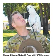  ?? ?? Above: Private Blake Mccrea with 3CER mascot Albie. Below: Members of 1RAR Band perform.