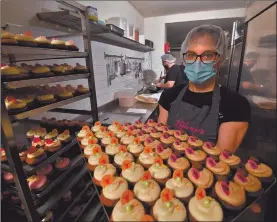  ?? Photo: Nampa/AFP ?? Moving on… Nolwenn Le Bonzec, a former nurse who quit her job at the Saint-Luc hospital during the first wave of the novel coronaviru­s Covid-19, holds a tray with cupcakes at Lilicupcak­e.