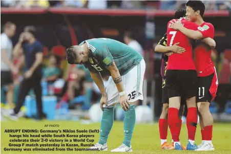  ?? AP PHOTO ?? ABRUPT ENDING: Germany’s Niklas Suele (left) hangs his head while South Korea players celebrate their 2-0 victory in a World Cup Group F match yesterday in Kazan, Russia. Germany was eliminated from the tournament.