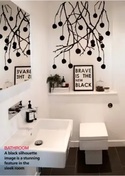  ??  ?? BATHROOM
A black silhouette image is a stunning feature in the sleek room